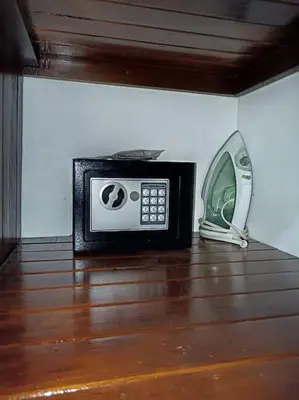 a microwave and a phone sitting on a wooden floor at Arenal Dreams House in Fortuna