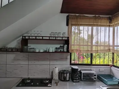 a kitchen with a stove and a window at Arenal Dreams House in Fortuna