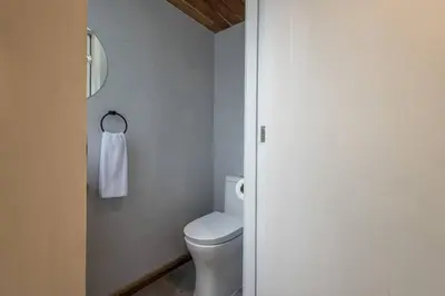a bathroom with a white toilet and a mirror at Casa Mariola the blissful studio in Mal País