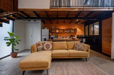 a living room with a couch and a kitchen at Casa Mariola the blissful studio in Mal País