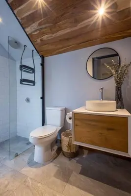 a bathroom with a toilet and a sink and a mirror at Casa Mariola the blissful studio in Mal País