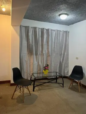 a room with a glass table and two chairs at Casa Aldaba in San José