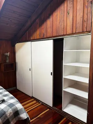 a room with white shelves and a bed at Casa Aldaba in San José