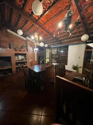 a dining room with a wooden table and chairs at Casa Aldaba in San José