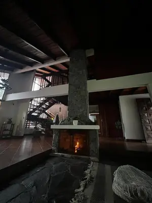 a living room with a fireplace in a building at Casa Aldaba in San José