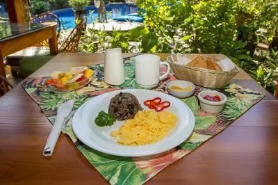 a table with a plate of food on a table at Hotel Villas Nicolas - Adults Only in Manuel Antonio