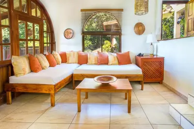 a living room with a couch and a table at Hotel Villas Nicolas - Adults Only in Manuel Antonio