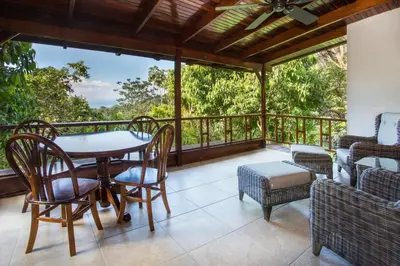 a patio with a table and chairs on a balcony at Hotel Villas Nicolas - Adults Only in Manuel Antonio