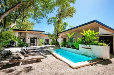 a swimming pool in the backyard of a house at Steps to the Main Surf Break - Casita 1 Dos Hijas in Refundores