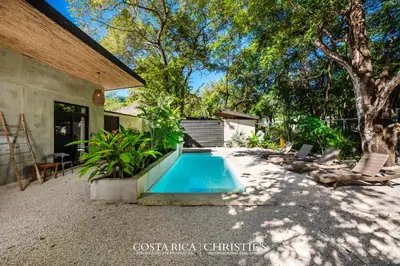 a swimming pool in the backyard of a house at Steps to the Main Surf Break Casita 2 Dos Hijas in Refundores