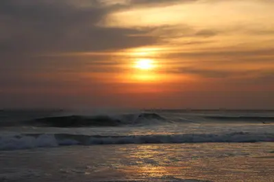a sunset over a beach with waves and the ocean at Steps to the Main Surf Break Casita 2 Dos Hijas in Refundores