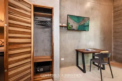 a dining room with a table and a chair at Steps to the Main Surf Break Casita 2 Dos Hijas in Refundores