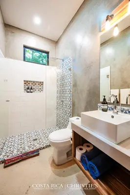 a bathroom with a sink and a toilet and a shower at Steps to the Main Surf Break - 3 Bedroom House in Refundores