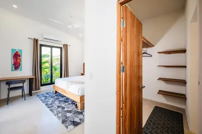 a bedroom with a bed and a desk in a room at Villa Serenity 6 bedroom - 1 minute to the beach in Santa Cruz