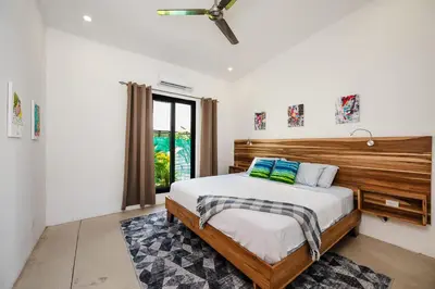 a bedroom with a bed and a ceiling fan at Villa Serenity 6 bedroom - 1 minute to the beach in Santa Cruz