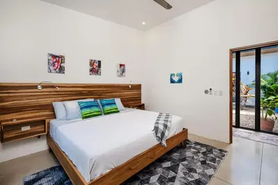 a bedroom with a bed and a window at Villa Serenity 6 bedroom - 1 minute to the beach in Santa Cruz