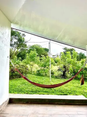 a hammock in a room with a large window at Miravalles Country House in Guayabal