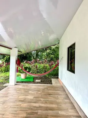 a patio with a red rope hanging from a building at Miravalles Country House in Guayabal