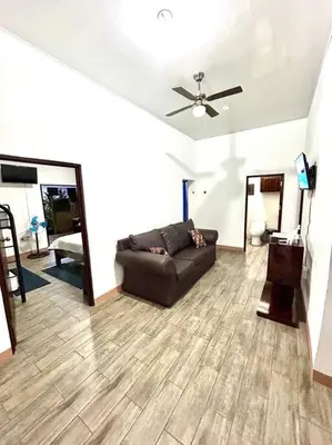 a living room with a couch and a ceiling fan at Miravalles Country House in Guayabal