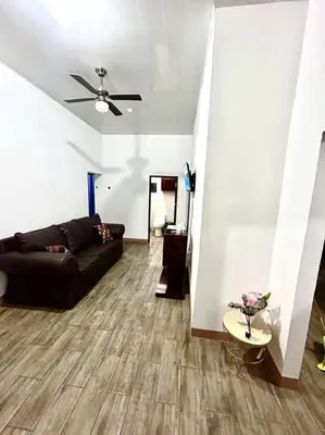 a living room with a couch and a ceiling fan at Miravalles Country House in Guayabal