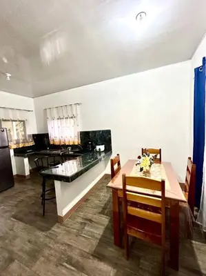 a kitchen with a table and a dining room at Miravalles Country House in Guayabal