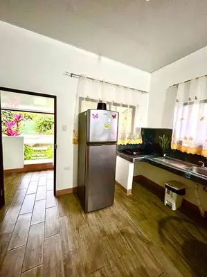 a kitchen with a refrigerator in the middle of a room at Miravalles Country House in Guayabal