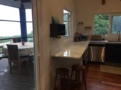 a kitchen with a counter and a table with chairs at #01 - Amazing Beachfront Bungalow!!!! in Playa Hermosa