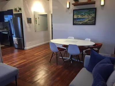 a living room with a table and chairs and a refrigerator at #01 - Amazing Beachfront Bungalow!!!! in Playa Hermosa