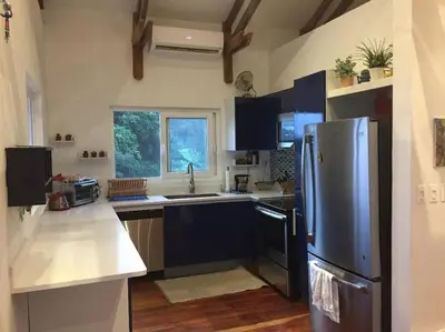 a kitchen with a stainless steel refrigerator and a window at #01 - Amazing Beachfront Bungalow!!!! in Playa Hermosa