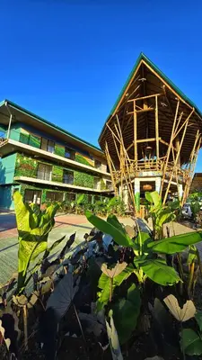 a building with a bunch of plants in front of it at Bonding Coffee Roaster Café & Hotel in Quepos