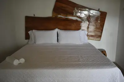 a bedroom with a bed with two towels on it at Bonding Coffee Roaster Café & Hotel in Quepos