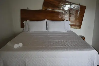 a bedroom with a bed with two towels on it at Bonding Coffee Roaster Café & Hotel in Quepos
