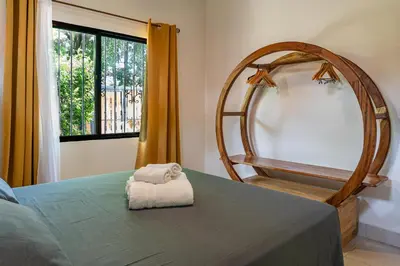 a bedroom with a mirror and a bed and a chair at Casa BEA 1 in Sámara