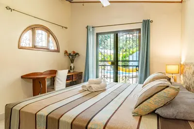 a bedroom with a large bed and a window at Casa BEA 1 in Sámara