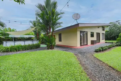 a small yellow house with a satellite at La Casa Amarilla in Fortuna