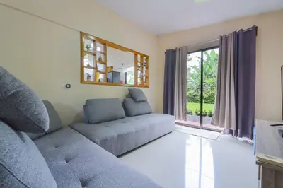 a living room with a couch and a window at La Casa Amarilla in Fortuna