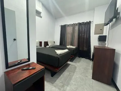 a small room with a bed and a mirror at Casa Tusi - 2 Blocks From Clubs & Strip in Jacó
