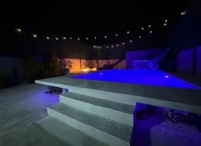 a swimming pool at night with purple lighting at Casa Tusi - 2 Blocks From Clubs & Strip in Jacó