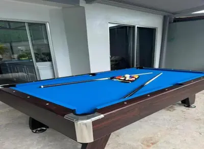 a blue pool table with two cuesticks on it at Casa Tusi - 2 Blocks From Clubs & Strip in Jacó