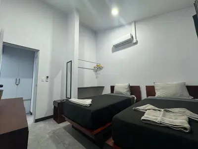 a room with two beds and a room with a door at Casa Tusi - 2 Blocks From Clubs & Strip in Jacó