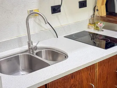 a stainless steel sink in a kitchen with a counter at Monte Green Villa Romántica con jacuzzi in Monteverde Costa Rica