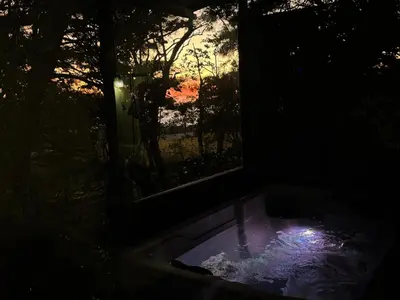 a bath tub in a dark room with a window at Monte Green Villa Romántica con jacuzzi in Monteverde Costa Rica