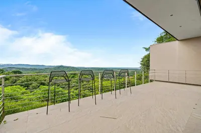 a balcony with four metal bars on the side of a building at Amazing Ocean and Mountain Views in Tamarindo