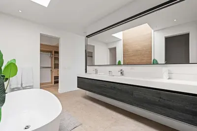 a bathroom with a tub and a large mirror at Amazing Ocean and Mountain Views in Tamarindo