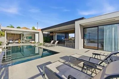 a house with a swimming pool and a patio at Amazing Ocean and Mountain Views in Tamarindo