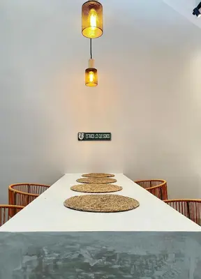a dining room table with chairs and lights at Marea Baja73 in Puntarenas