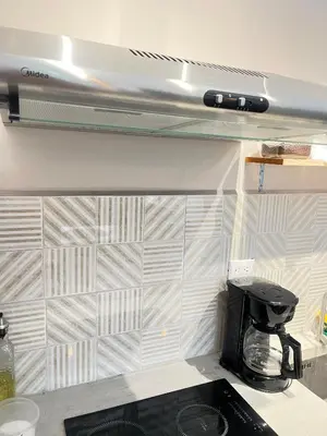 a kitchen with a counter top with a tile wall at Marea Baja73 in Puntarenas