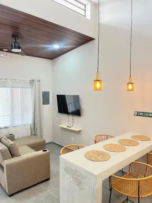 a living room with a table and a couch at Marea Baja73 in Puntarenas