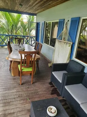 a patio with a table and chairs on a porch at #8 Ocean view Beach Front Bungalow 2nd Row in Playa Hermosa
