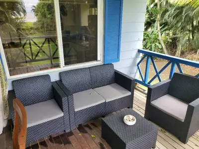 two chairs and a table on a porch at #8 Ocean view Beach Front Bungalow 2nd Row in Playa Hermosa